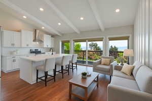 Living area with dark wood finished floors and recessed lighting