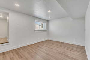 Spare room with light wood-type flooring and recessed lighting