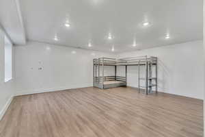 Additional living space featuring light wood-style flooring and recessed lighting