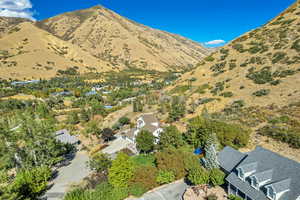 Aerial view of property's location featuring a mountainous background and nearby suburban area