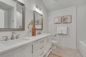Primary bathroom with Full bathroom featuring double vanity and shower / bath combination