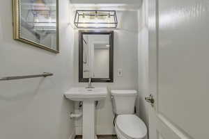 Half bath with toilet and baseboards