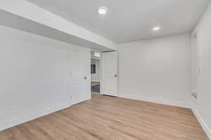Unfurnished room with light wood finished floors and recessed lighting