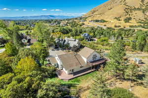 View from above of property featuring a tree filled landscape and a mountainous background