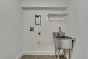 Laundry room featuring washer hookup, wood finished floors, and hookup for an electric dryer
