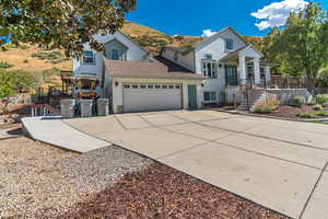 Traditional-style home featuring driveway, stairway, an attached garage, a mountain view, and brick siding