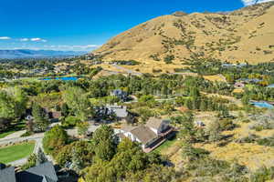 Aerial view of property and surrounding area with a water and mountain view