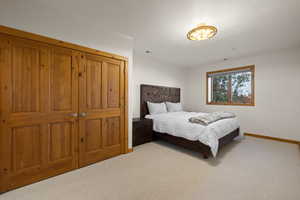 Carpeted bedroom featuring baseboards