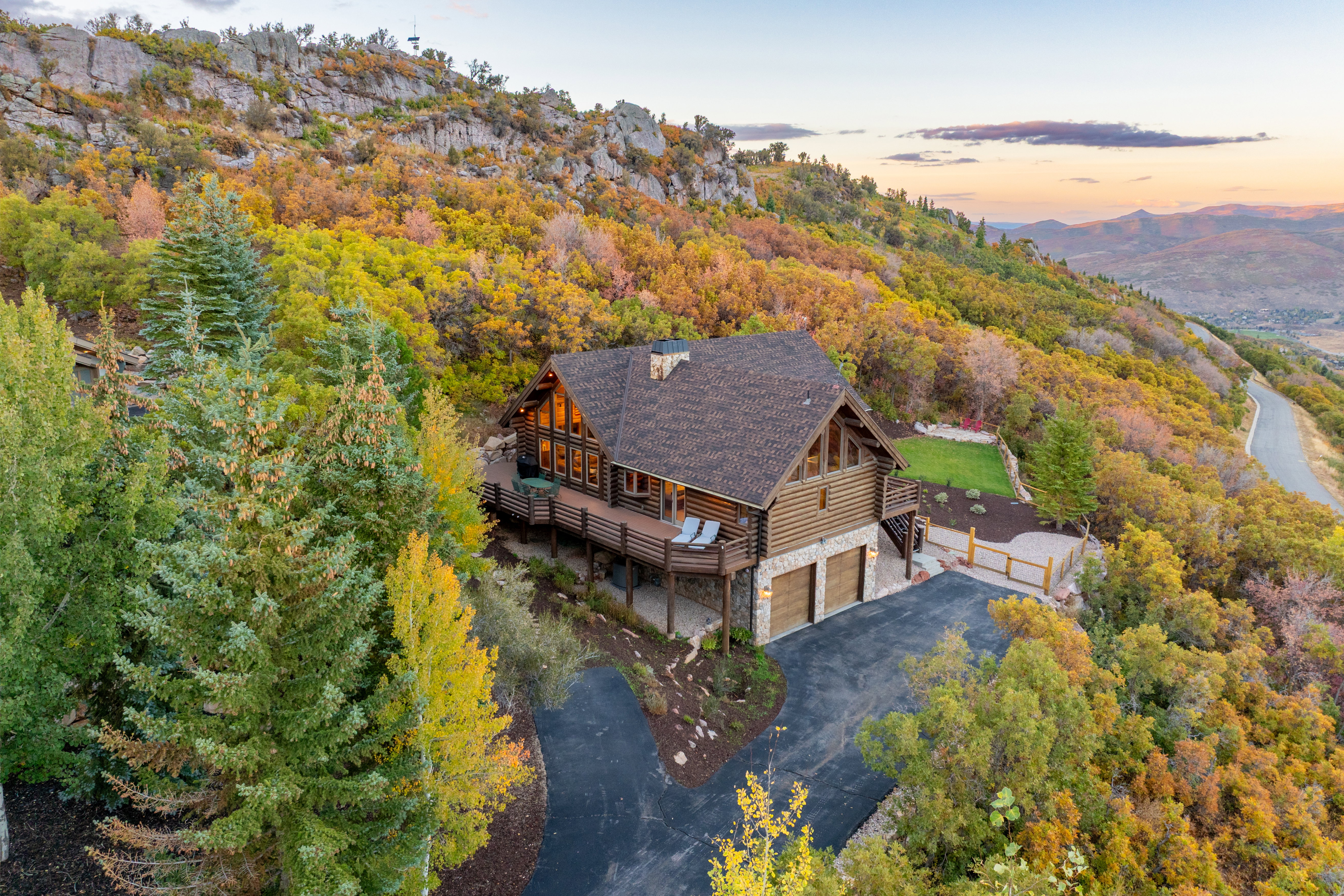 View of subject property with a forest and a mountainous background