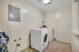 Washroom with electric panel and washing machine and clothes dryer