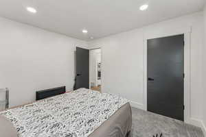 Bedroom featuring light colored carpet and recessed lighting