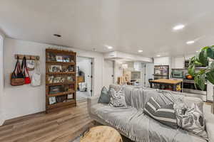 Living area featuring light wood-style flooring, recessed lighting, and a textured ceiling