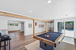 Game room featuring billiards table, healthy amount of natural light, recessed lighting, wood finished floors, and a textured ceiling