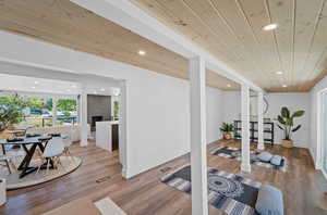Exercise area featuring light wood-type flooring, recessed lighting, and wood ceiling