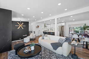 Living room with wood finished floors and recessed lighting