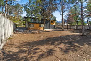 Back of house with a fenced backyard