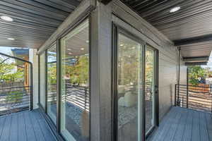 Doorway to outside featuring wood-type flooring, recessed lighting, wood walls, and expansive windows