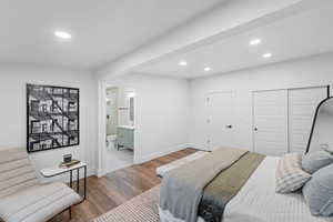 Bedroom featuring recessed lighting, wood finished floors, and ensuite bath