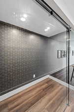 Interior space with dark wood-style flooring and recessed lighting