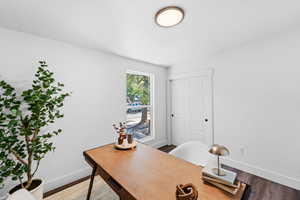 Office space with baseboards and light wood-type flooring