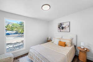 Bedroom with wood finished floors and baseboards