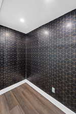 Unfurnished room with wood finished floors and a textured ceiling