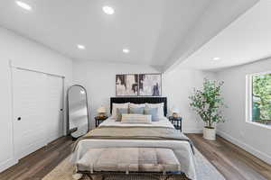 Bedroom with recessed lighting, dark wood-style floors, and a closet