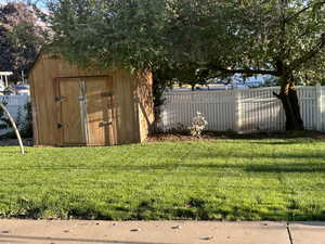 View of shed featuring a fenced backyard