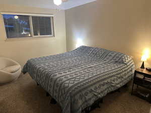 Bedroom featuring a textured wall and carpet floors