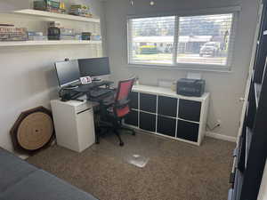 Carpeted home office with healthy amount of natural light