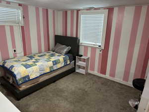 Bedroom with carpet flooring and wallpapered walls