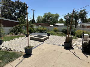 Fenced backyard with a patio area and an outdoor fire pit