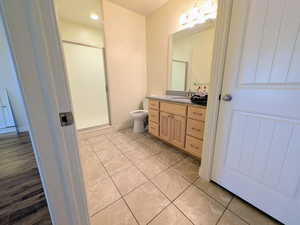 Bathroom featuring a shower stall, vanity, and light tile patterned floors