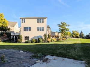 Back of house with a lawn