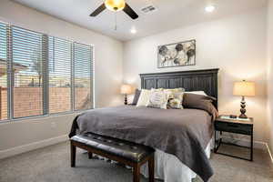 Bedroom with light carpet, a ceiling fan, and recessed lighting