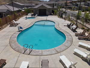 Community pool featuring a patio, a community hot tub, a residential view, and a pergola