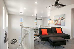 Living area with a ceiling fan, an upstairs landing, light carpet, and recessed lightingBonus Room
