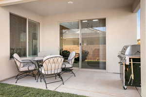 View of patio with outdoor dining area and area for grilling