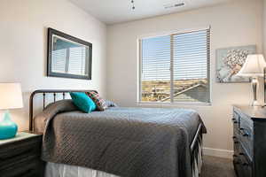Bedroom with carpet flooring and baseboards