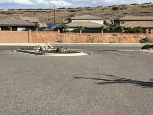 View of asphalt street featuring curbs