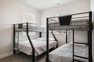 Carpeted bedroom featuring baseboards