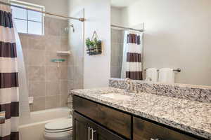 Full bath featuring shower / bathtub combination with curtain and vanity