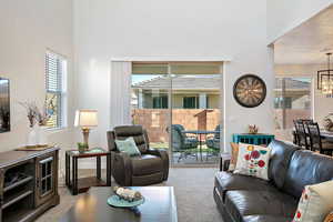 Living room featuring carpet flooring and a chandelier