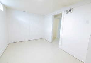 Unfurnished room featuring finished concrete floors