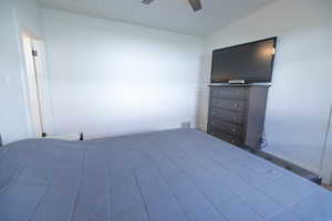 Bedroom featuring ceiling fan and lofted ceiling