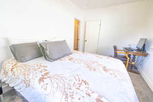 Carpeted bedroom featuring baseboards