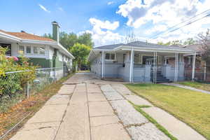 View of front of home featuring a porch, concrete driveway, and roof with shingles