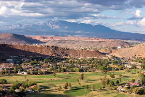 View of mountain backdrop featuring a local golf course and nearby suburban area