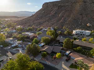 Aerial overview of property's location featuring nearby suburban area and a mountain backdrop
