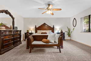 Bedroom featuring light colored carpet and a ceiling fan
